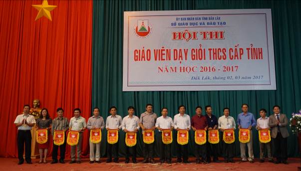 Ông Thái Văn Tài - Phó Giám đốc Sở GDĐT và ông Nguyễn Đức Trản - Chủ tịch Công đoàn ngành tặng Cờ lưu niệm của Ban Tổ chức cho các Phòng GDĐT